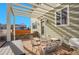 Relaxing patio area with a pergola, outdoor seating, and views of the neighborhood at 3406 Purcell St, Brighton, CO 80601