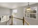 Staircase with white railings and ample natural light from the windows at 3406 Purcell St, Brighton, CO 80601
