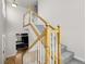 Staircase leading upstairs with a neutral carpet runner and natural wood banister at 3406 Purcell St, Brighton, CO 80601