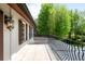 Elegant balcony with wrought iron railing and outdoor lighting, offering a scenic view of the surrounding greenery at 5 Churchill Dr, Cherry Hills Village, CO 80113