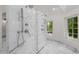 Luxurious marble-tiled shower with dual shower heads and natural light pouring through the windows at 5 Churchill Dr, Cherry Hills Village, CO 80113