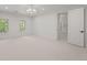 Bright bedroom featuring neutral carpet, large windows, an ornate chandelier, and an open door at 5 Churchill Dr, Cherry Hills Village, CO 80113