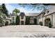 Stately home featuring a circular driveway and manicured landscaping at 5 Churchill Dr, Cherry Hills Village, CO 80113