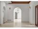 Elegant foyer with hardwood floors, arched doorways, and chandelier lighting at 5 Churchill Dr, Cherry Hills Village, CO 80113
