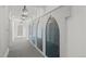 Elegant hallway featuring decorative arched windows and sophisticated pendant lighting at 5 Churchill Dr, Cherry Hills Village, CO 80113