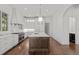 Modern kitchen with stainless appliances, large island, and hardwood floors at 5 Churchill Dr, Cherry Hills Village, CO 80113