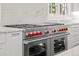 Modern kitchen features a large stainless steel range with double ovens and marble backsplash at 5 Churchill Dr, Cherry Hills Village, CO 80113