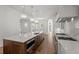 Large kitchen with wood floors, a kitchen island, stainless appliances, and custom lighting at 5 Churchill Dr, Cherry Hills Village, CO 80113