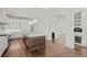 Open-concept kitchen with wood floors, a large island, stainless appliances, and white cabinetry at 5 Churchill Dr, Cherry Hills Village, CO 80113
