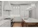Bright kitchen featuring custom cabinets, marble countertops, pendant lights, and stainless appliances at 5 Churchill Dr, Cherry Hills Village, CO 80113