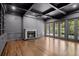 Living room with dark walls, a coffered ceiling, fireplace, and exterior doors at 5 Churchill Dr, Cherry Hills Village, CO 80113
