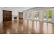 Spacious living room with herringbone floors, fireplace, and French doors at 5 Churchill Dr, Cherry Hills Village, CO 80113