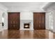 Cozy living room boasting a fireplace, custom cabinetry, and herringbone floors at 5 Churchill Dr, Cherry Hills Village, CO 80113