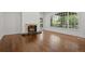 Spacious living room with wood floors, a fireplace, large window, and exterior doors at 5 Churchill Dr, Cherry Hills Village, CO 80113