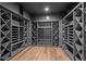 Climate-controlled wine cellar with custom shelving and wood-look floor for optimal storage at 5 Churchill Dr, Cherry Hills Village, CO 80113