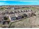 An aerial view of homes situated in a neighborhood with a golf course and rolling hills in the background at 23757 Eagle Bend Ln, Parker, CO 80138