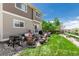 A charming outdoor patio with wicker seating, a grill, and a lush green lawn, ideal for relaxation and entertainment at 23757 Eagle Bend Ln, Parker, CO 80138