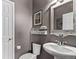 Cozy bathroom featuring a pedestal sink, framed mirror, decorative shelving, and a fresh toilet at 23757 Eagle Bend Ln, Parker, CO 80138