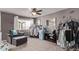 A charming bedroom features a ceiling fan, window, an armchair, clothing racks, and a small refrigerator at 23757 Eagle Bend Ln, Parker, CO 80138