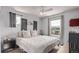 Cozy bedroom with two windows, modern ceiling fan, and comfortable bed with soft lighting at 23757 Eagle Bend Ln, Parker, CO 80138