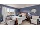 This spacious bedroom features a large window, wood furniture, soft carpet and modern decor at 23757 Eagle Bend Ln, Parker, CO 80138