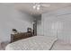 Bedroom features neutral carpet, ceiling fan, closet, wood dresser, and modern decor at 23757 Eagle Bend Ln, Parker, CO 80138