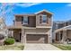 Charming two-story home featuring a two-car garage, complemented by neutral siding and stone accents at 23757 Eagle Bend Ln, Parker, CO 80138