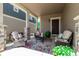 Inviting front porch with stylish wicker furniture and a colorful rug, perfect for relaxing outdoors at 23757 Eagle Bend Ln, Parker, CO 80138