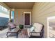 Inviting covered front porch with comfortable seating, perfect for relaxing outdoors at 23757 Eagle Bend Ln, Parker, CO 80138