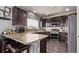 Well-equipped kitchen featuring dark cabinets, stainless steel appliances, and a breakfast bar for casual dining at 23757 Eagle Bend Ln, Parker, CO 80138