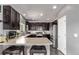 Modern kitchen featuring dark cabinetry, stainless steel appliances, and a breakfast bar with stool seating at 23757 Eagle Bend Ln, Parker, CO 80138