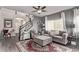 Comfortable living room with plush seating, a ceiling fan, and a large window providing ample natural light at 23757 Eagle Bend Ln, Parker, CO 80138