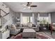 Cozy living room featuring plush seating, a ceiling fan, and ample natural light at 23757 Eagle Bend Ln, Parker, CO 80138