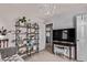 Living room view with comfortable seating, large bookcase filled with plants, and view to laundry room at 23757 Eagle Bend Ln, Parker, CO 80138