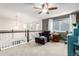 Cozy upstairs loft area featuring comfortable seating, natural light, and views of the lower level at 23757 Eagle Bend Ln, Parker, CO 80138
