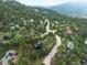 Aerial view of the home and community nestled in a wooded area at 28833 Western Dr, Evergreen, CO 80439