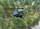 Aerial view of home nestled in a wooded area with mature trees at 28833 Western Dr, Evergreen, CO 80439