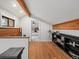 Finished attic room with wood floors, built-in shelving, and a view of the main bedroom at 28833 Western Dr, Evergreen, CO 80439