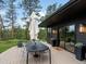 Back patio deck with dining and seating surrounded by trees at 28833 Western Dr, Evergreen, CO 80439