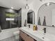 Modern bathroom with double sinks, stylish mirrors, unique light fixtures, and a walk-in shower at 28833 Western Dr, Evergreen, CO 80439