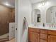 Bright bathroom featuring a walk-in shower and dual sinks with elegant mirrors and lighting at 28833 Western Dr, Evergreen, CO 80439