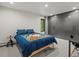 This bedroom features a blue quilt, gray closet, and a large window at 28833 Western Dr, Evergreen, CO 80439