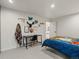 Bright bedroom with modern decorations, a desk, and an attached room with wood flooring at 28833 Western Dr, Evergreen, CO 80439