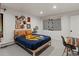 Nicely decorated bedroom featuring a blue quilt, modern decor, and a light wood bedframe at 28833 Western Dr, Evergreen, CO 80439