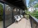 Relaxing deck with comfortable seating and sliding glass doors offering outdoor living space with natural surroundings at 28833 Western Dr, Evergreen, CO 80439