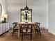 Cozy dining room featuring a wood table, stylish chairs, pendant lighting, and a bright window with natural light at 28833 Western Dr, Evergreen, CO 80439