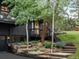 Charming home with a dark exterior, stone accents, and lush landscaping at 28833 Western Dr, Evergreen, CO 80439