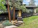 Beautiful dark home with a wooden front porch and steps at 28833 Western Dr, Evergreen, CO 80439