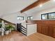 Hallway featuring wood floors, wood accents, and lots of windows at 28833 Western Dr, Evergreen, CO 80439