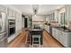 Modern kitchen with stainless steel appliances, gray cabinets, black countertops, and a large island with seating at 28833 Western Dr, Evergreen, CO 80439